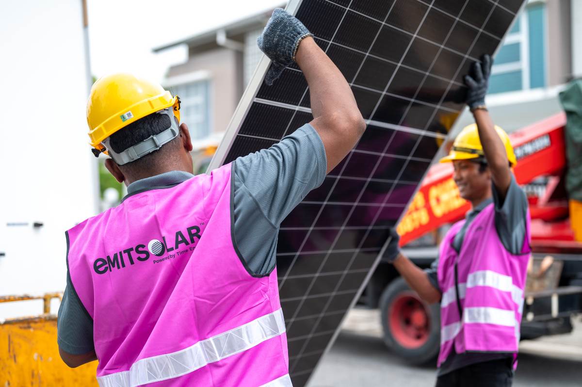 Emit Solar installers unloading a panel on site